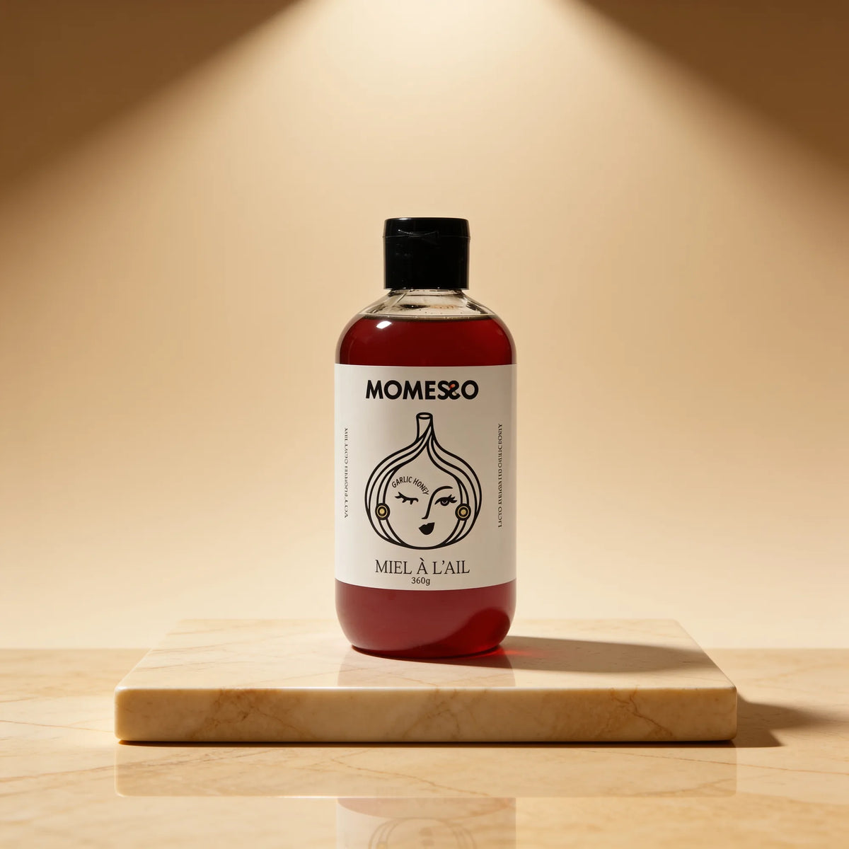 Momesso Garlic Honey bottle on a marble plinth
